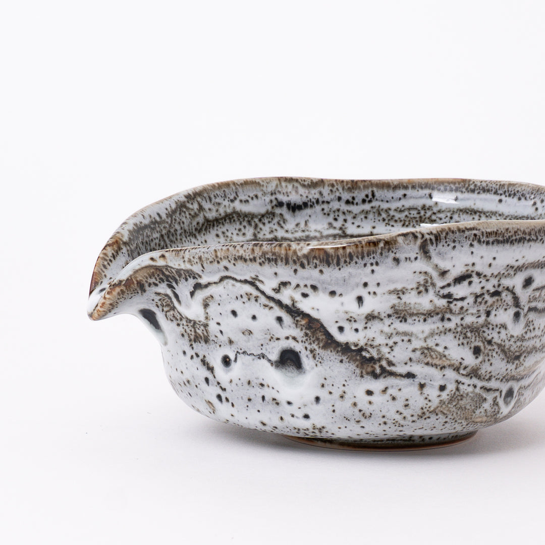 Front view of a Japanese Mino Ware Flowing Glaze Katakuchi Matcha Bowl featuring a flowing white glaze with natural brown kiln-fired patterns.