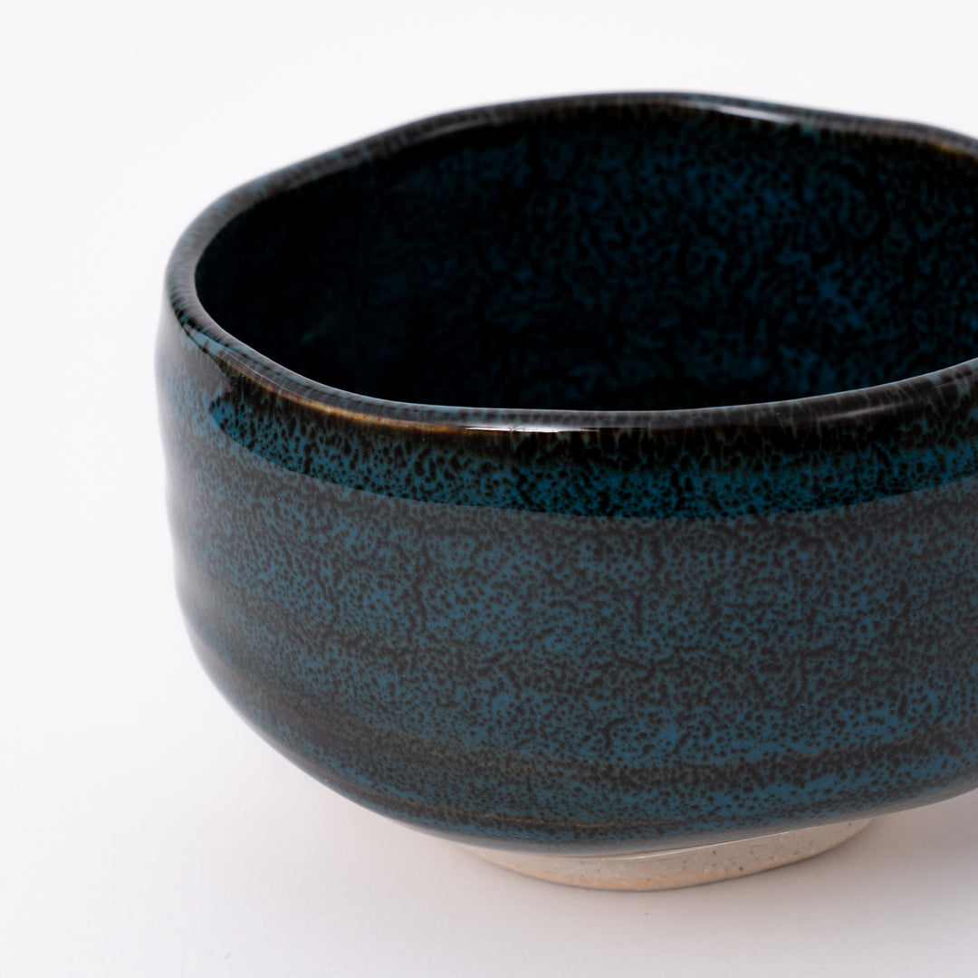 Side view of a handmade Mino Ware Ao Tenmoku Matcha Bowl showcasing its rounded shape and glossy glaze.