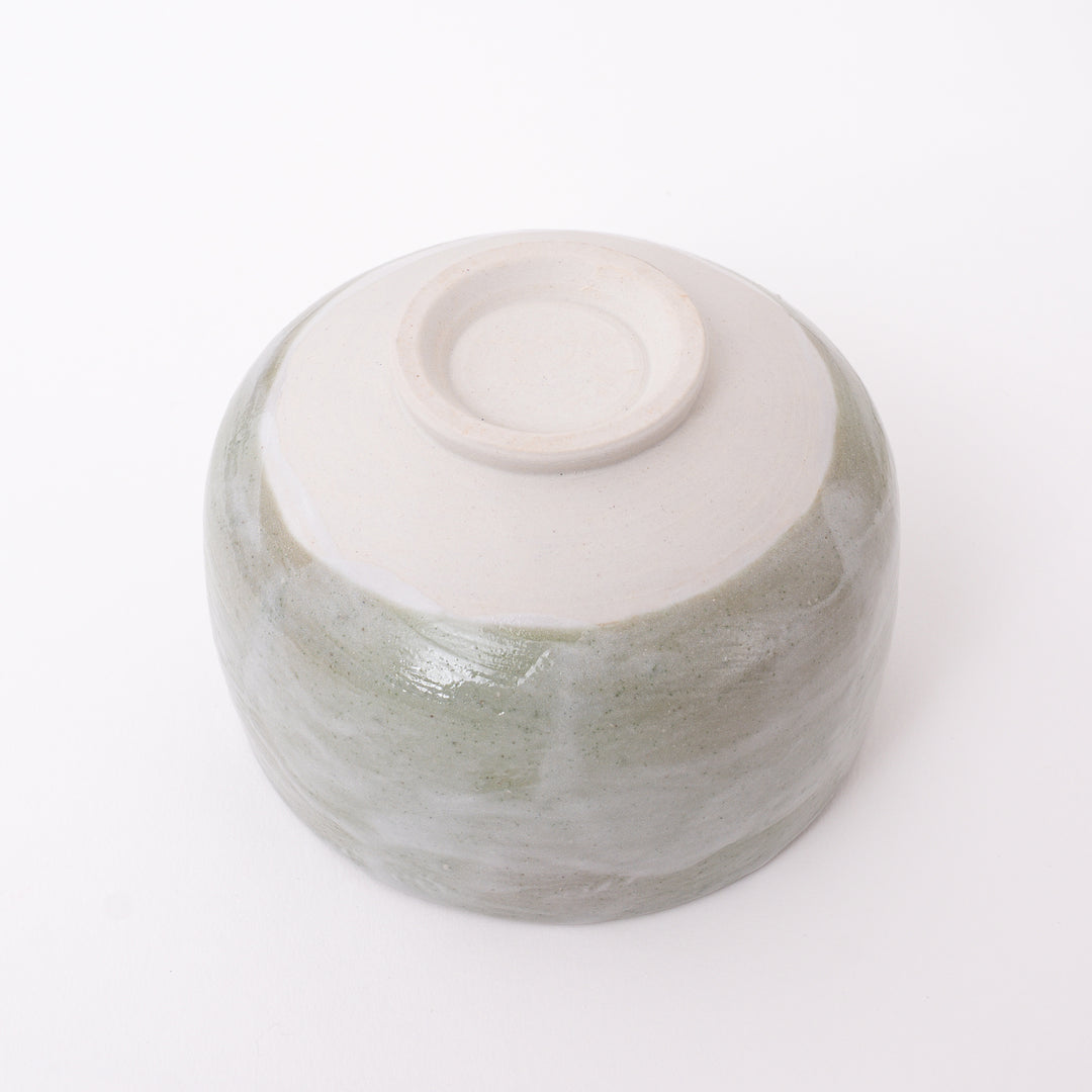 Bottom view of a handmade Japanese Mino Ware ceramic matcha bowl showing the traditional foot ring and maker's mark.