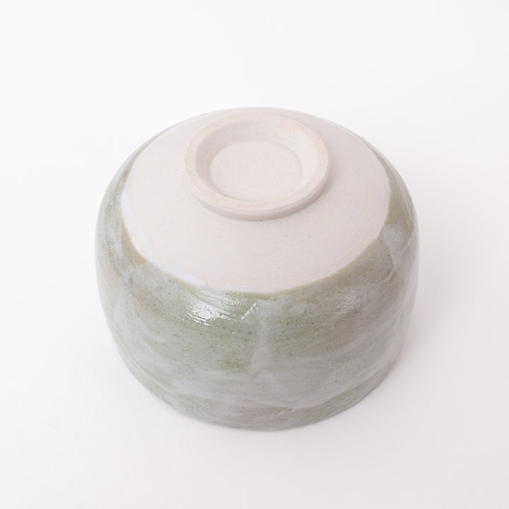 Bottom view of a handmade Japanese Mino Ware ceramic matcha bowl showing the traditional foot ring and maker's mark.