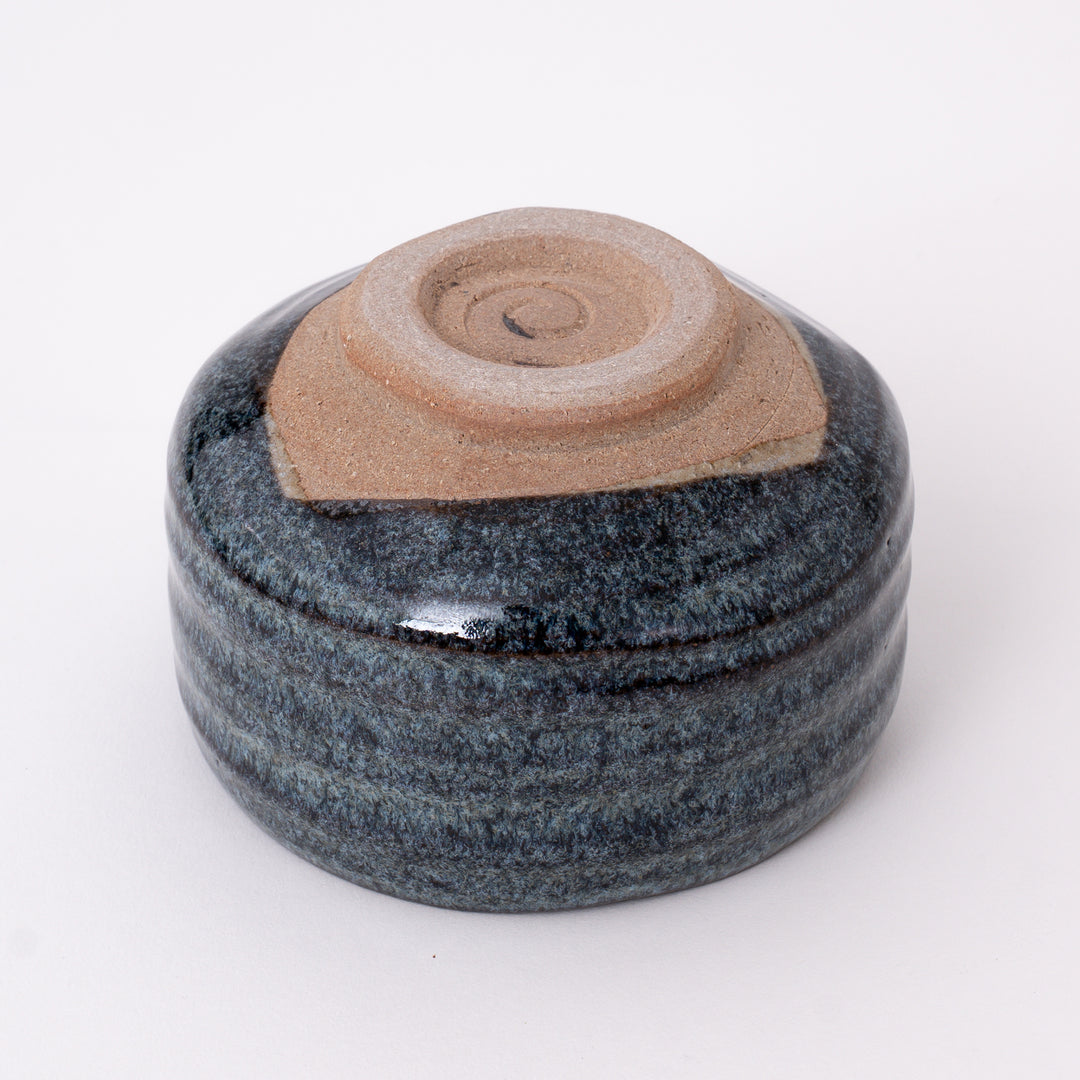 Bottom view of a handmade Japanese Mino Ware ceramic matcha bowl showing the traditional foot ring and maker's mark.