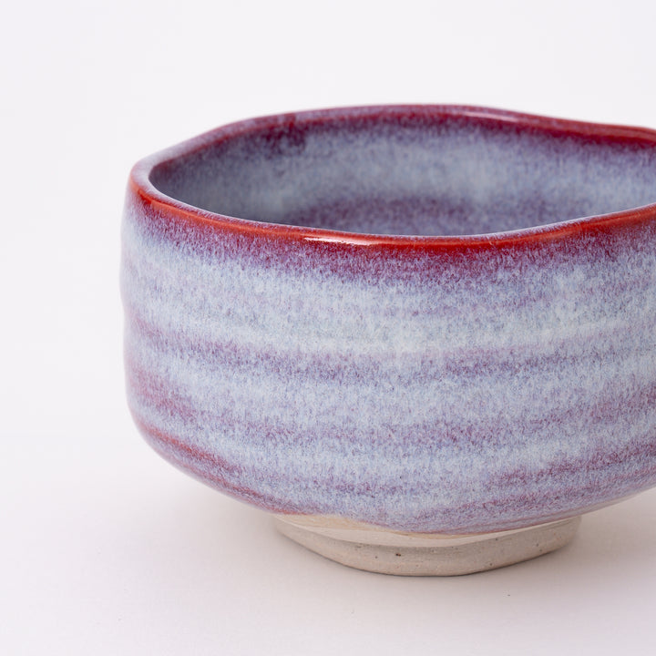 Back view of an authentic Japanese ceramic matcha bowl with a soft Sakura Unofu glaze.