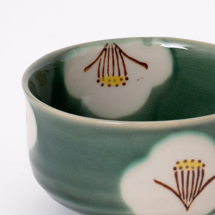 Back view of an authentic Japanese Seto Ware Oribe Camellia Matcha Bowl with a continuous green glaze finish.