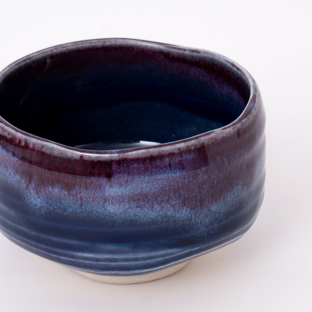 Front view of a Japanese Mino Ware matcha bowl featuring a layered purple and blue glaze.