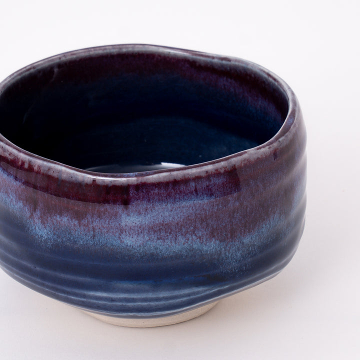 Front view of a Japanese Mino Ware matcha bowl featuring a layered purple and blue glaze.