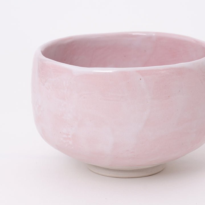 Back view of an authentic Mino Ware Sakura Pink Shino ceramic matcha bowl with a naturally flowing pink glaze.