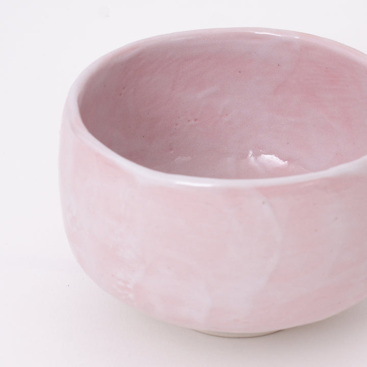 Close-up of the soft Sakura Pink Shino glaze with natural variations on a handcrafted Japanese matcha bowl.