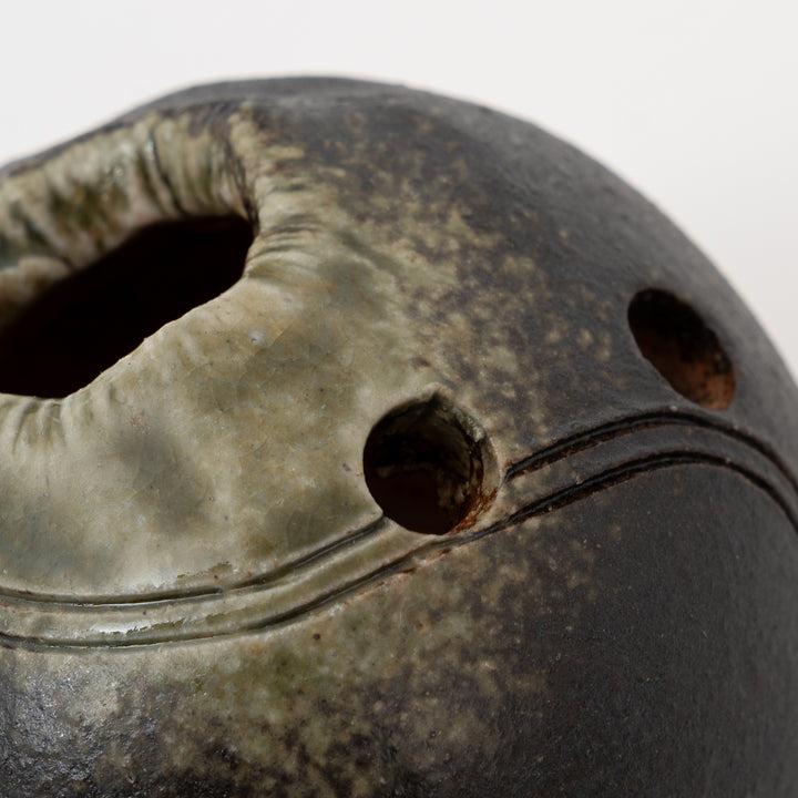 Large flower opening and small accent holes on charcoal Shigaraki mini vase