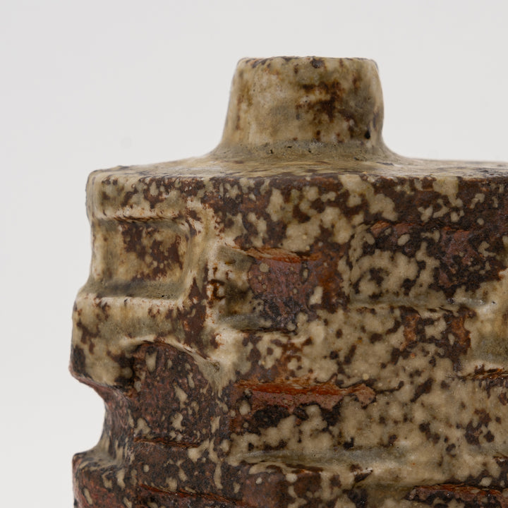 Close-up of mottled cream and brown glaze on Shigaraki mini vase