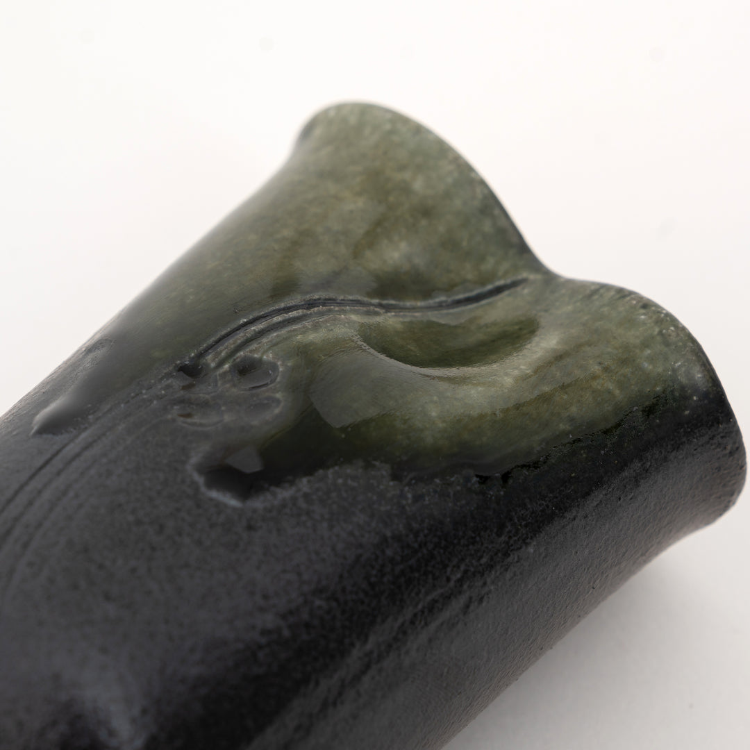 Close-up of carved botanical detail on olive green Shigaraki mini vase