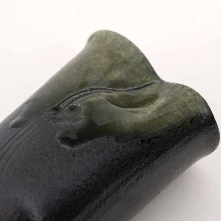 Close-up of carved botanical detail on olive green Shigaraki mini vase