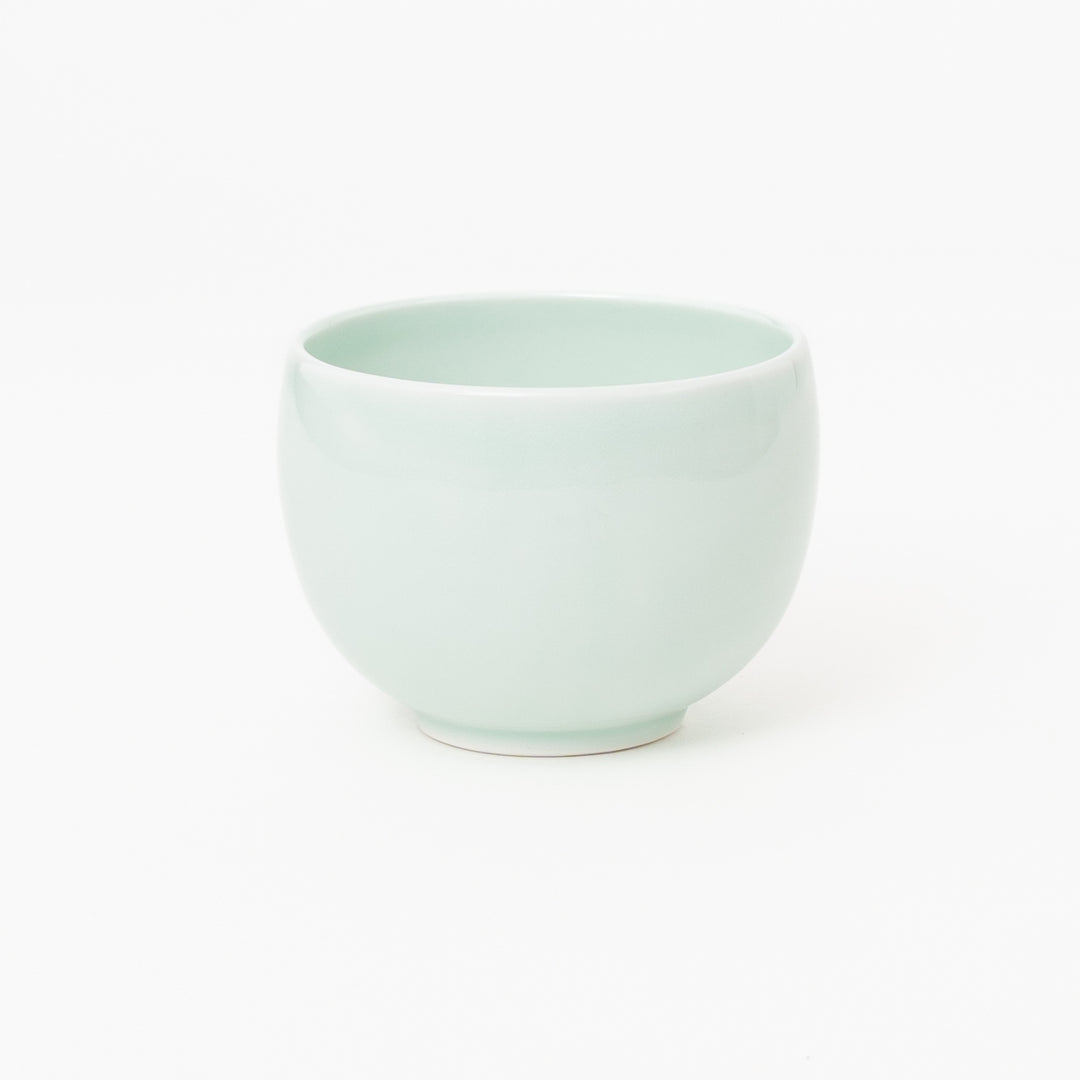 Pale celadon Japanese ceramic tea bowl with rounded shape
