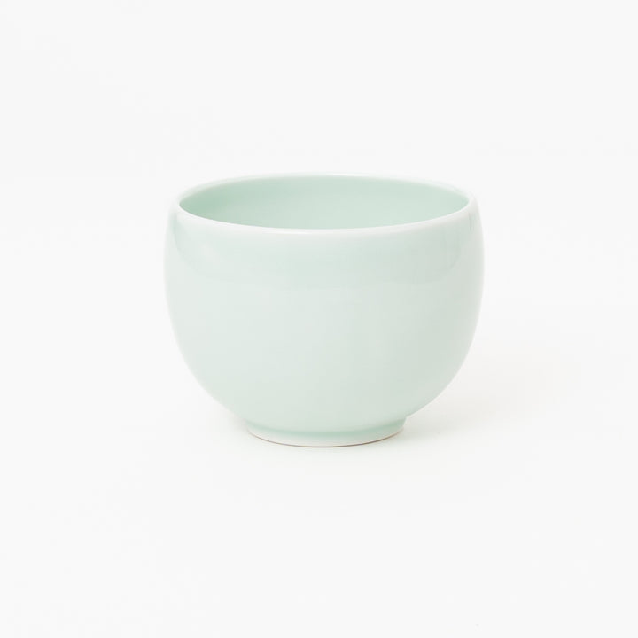 Pale celadon Japanese ceramic tea bowl with rounded shape
