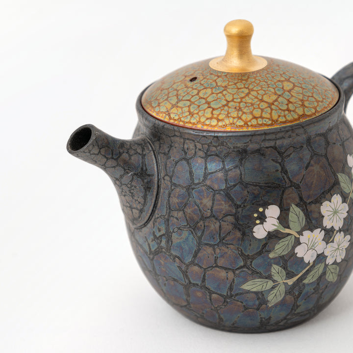 Close view of cherry blossoms on a Shoryu Tenmoku teapot