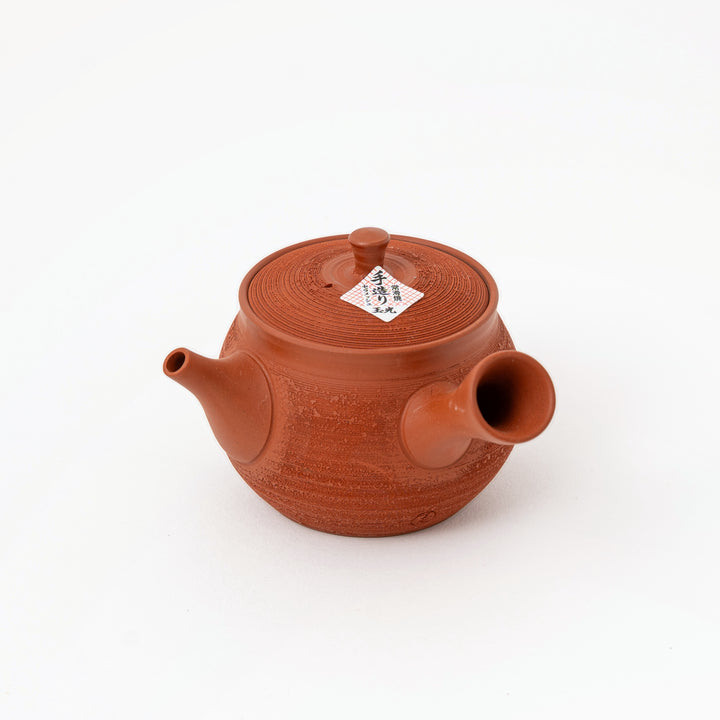Fine granular pine-bark texture on Japanese red clay tea pot