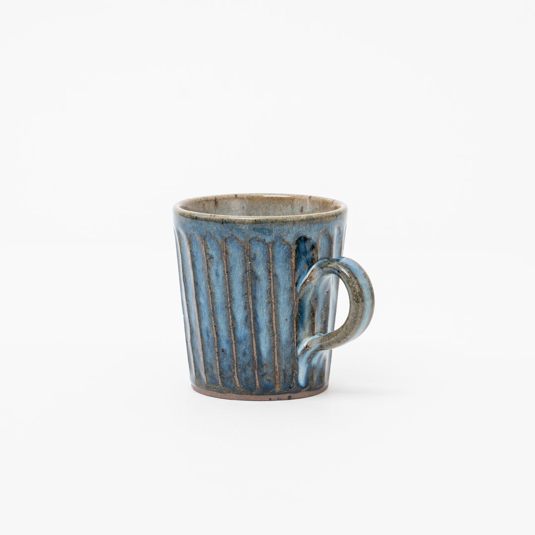 Handmade Japanese ceramic mug with a ridged design and earthy blue tones, perfect for coffee or tea