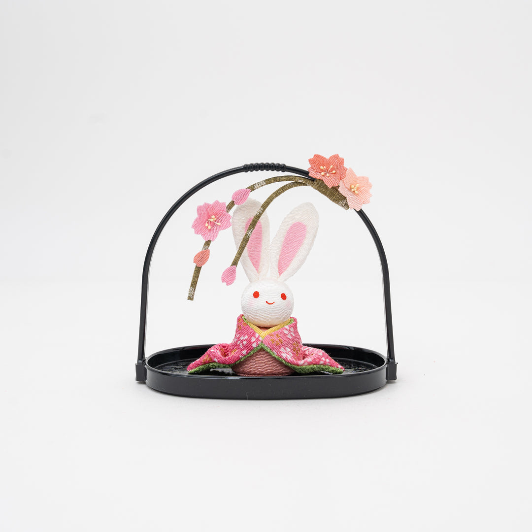 pink kimono rabbit in a black basket with cherry blossom on it