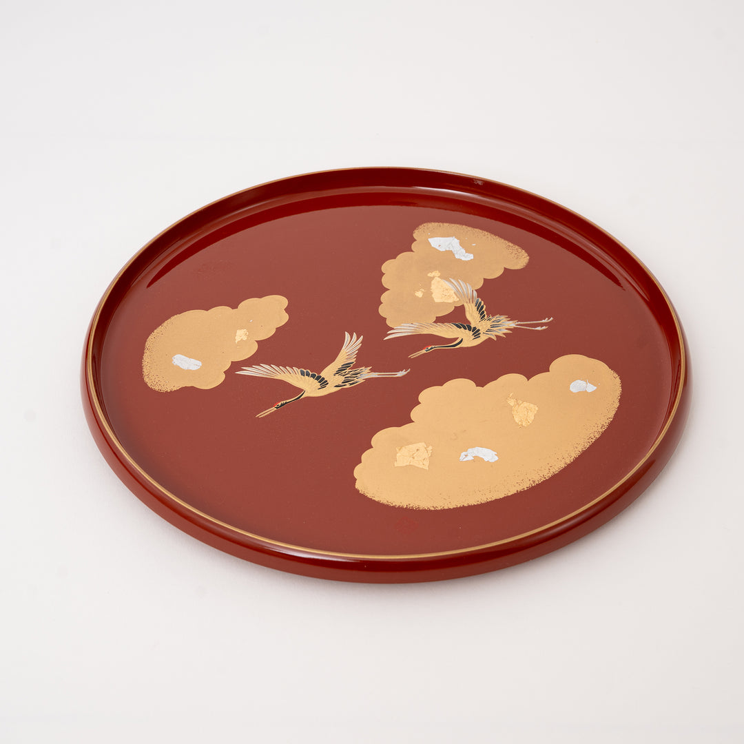 Japanese lacquer serving tray with gold and silver leaf flying cranes on vermilion red round resin tray made in Japan.