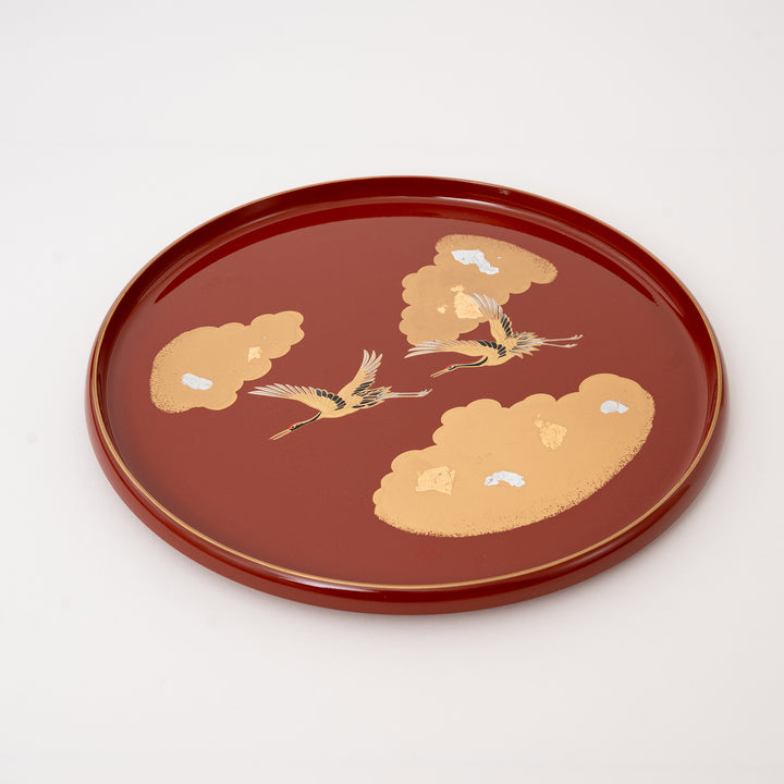 Japanese lacquer serving tray with gold and silver leaf flying cranes on vermilion red round resin tray made in Japan.