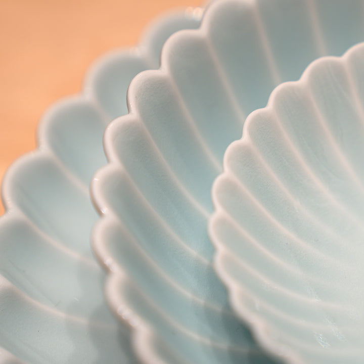 Stacked Hasami chrysanthemum plates and bowls in blue porcelain