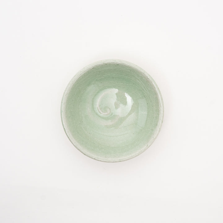 Handmade Japanese celadon dish with a vortex design and crackle glaze