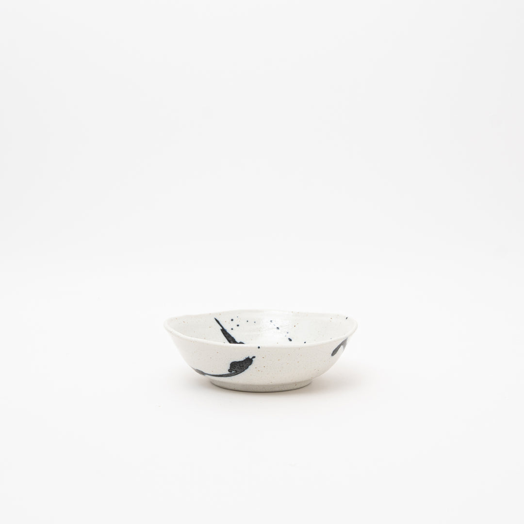 Handmade Japanese small bowl with Kuresu-nagashi cobalt blue glaze pattern on cream ceramic surface