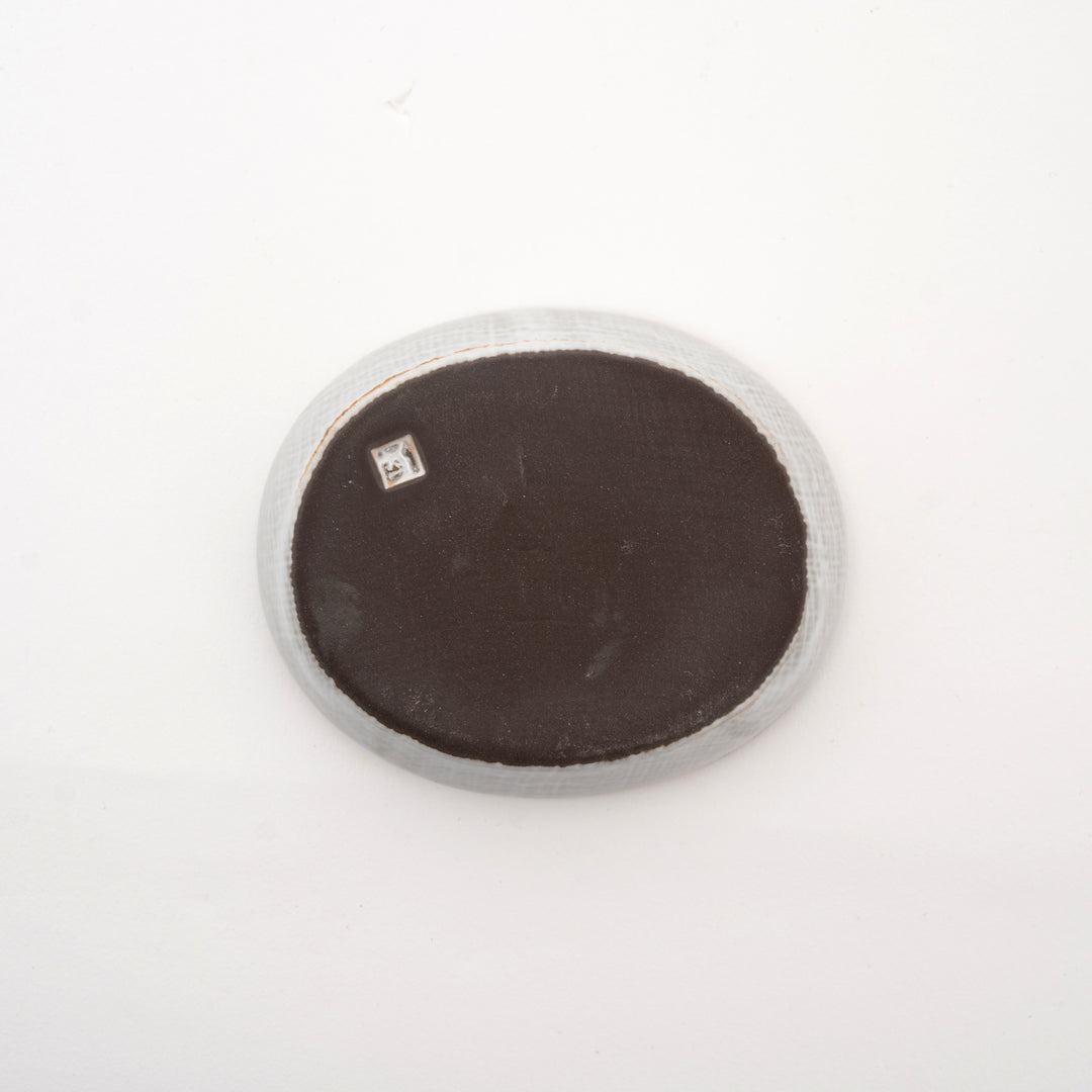 
Authentic Japanese red clay ceramic dish with organic oval shape and mesmerizing speckled glaze pattern