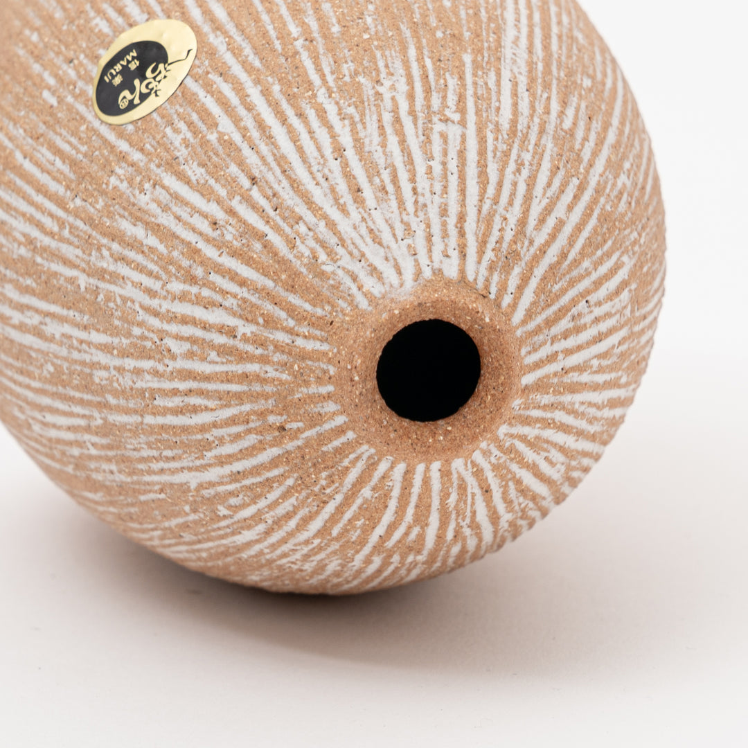Close-up of the textured, unglazed base and white streaking detail of the authentic Shigaraki ceramic vase.